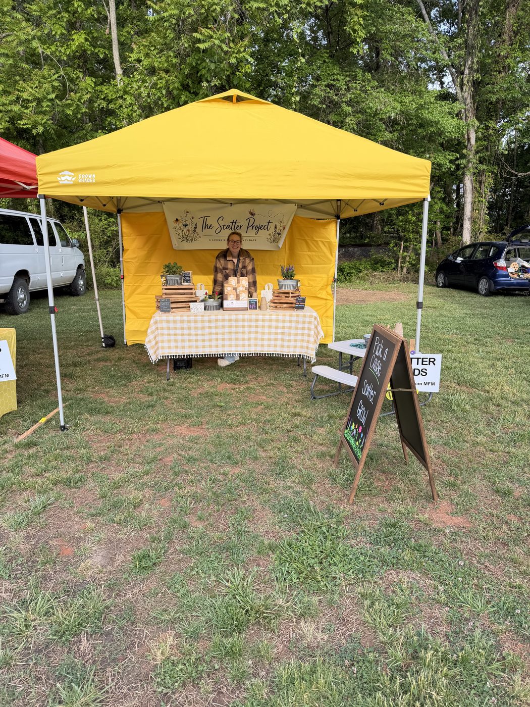 Alli at a Scatter Project farmers market booth
